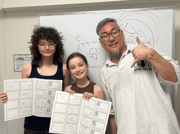 Bright classroom tables with learners sketching
